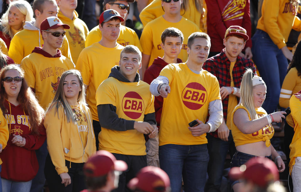 Iowa State students wear yellow shirts with "CBA" to honor slain student Celia Barquin Arozamena before an NCAA college football game between Iowa State and Akron, Saturday, Sept. 22, 2018, in Ames, Iowa. Barquin, who was the 2018 Big 12 women's golf champion and Iowa State Female Athlete of the Year, was found Monday morning in a pond at a golf course near the Iowa State campus. (AP Photo/Charlie Neibergall)