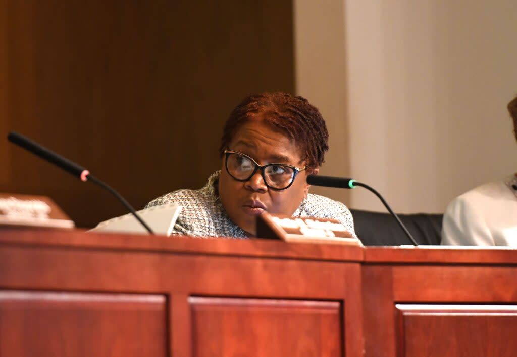 Alabama State Board of Education member Tonya Chestnut, her head turned, listens to a colleague.