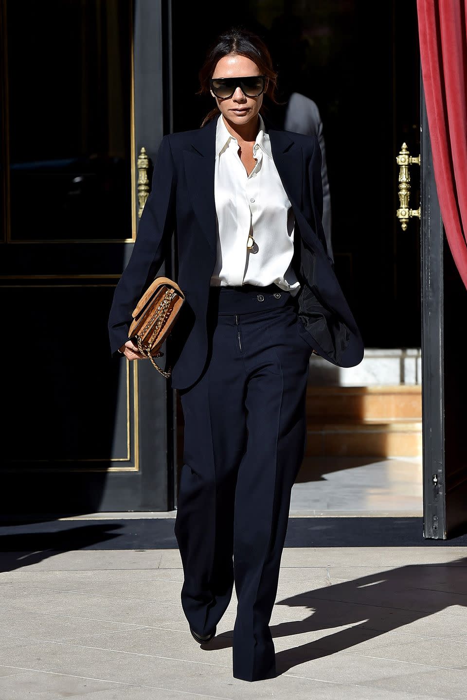 <p><strong>September 2018 </strong>Victoria Beckham looked effortlessly chic in a navy trouser suit during Paris Fashion Week.</p>