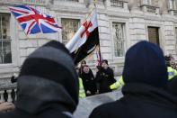 Nationalist demonstrators shout at Muslim demonstrators protesting against the publication of cartoons depicting the Prophet Mohammad in French satirical weekly Charlie Hebdo, near Downing Street in central London February 8, 2015. REUTERS/Stefan Wermuth