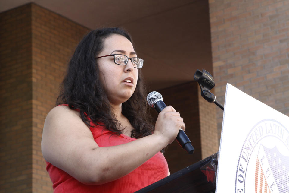 Jessica Coca Garcia stands in front of her wheelchair addressing those gathered at the League of United Latin American Citizens' "March for a United America" Saturday, Aug. 10, 2019 in El Paso, Texas. More than 100 people marched through the Texas border denouncing racism and calling for stronger gun laws one week after several people were killed in a mass shooting that authorities say was carried out by a man targeting Mexicans. Garcia and her husband were injured during the mass shooting. (AP Photo/Cedar Attanasio)