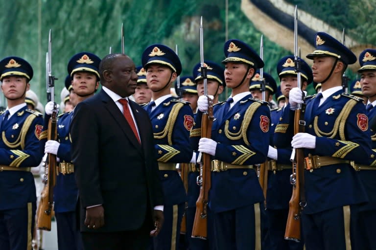 South Africa's President Cyril Ramaphosa reviews an honour guard at the Great Hall of the People