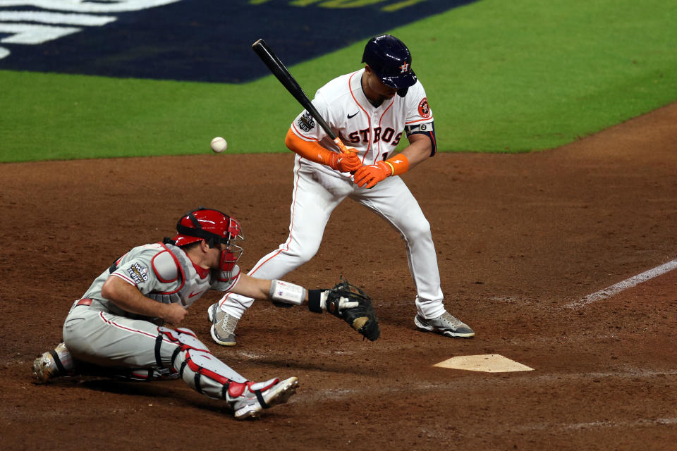 HOUSTON, TEXAS - OCTOBER 28: A wild pitch bounces away from J.T. Realmuto #10 of the Philadelphia Phillies as Aledmys Diaz #16 of the Houston Astros bats in the 10th inning in Game One of the 2022 World Series at Minute Maid Park on October 28, 2022 in Houston, Texas. (Photo by Rob Carr/Getty Images)