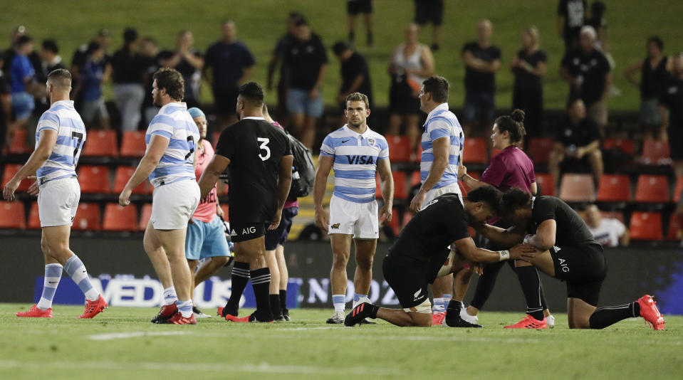 New Zealand's Ardie Savea and teammate Caleb Clarke, right, kneel and pray following the Tri-Nations rugby test between Argentina and the All Blacks in Newcastle, Australia, Saturday, Nov. 28, 2020. (AP Photo/Rick Rycroft)