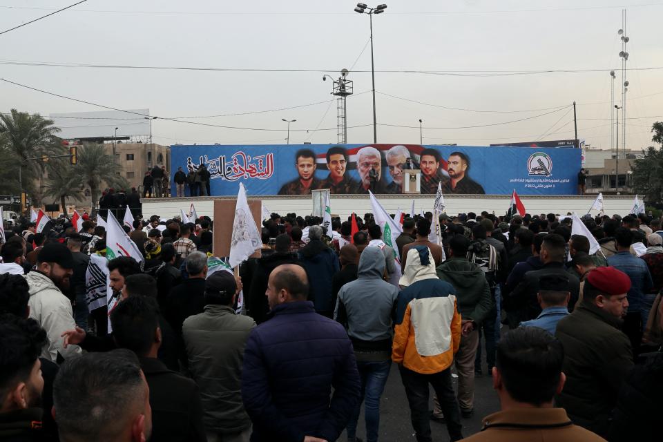 Supporters and members of the Popular Mobilization Forces chant slogans in Baghdad, Iraq, Saturday, Jan. 1, 2022. Hundreds rally in Baghdad on Soleimani assassination anniversary, chanting anti-American slogans, hundreds of people rallied in in the Iraqi capital on the first day of the year Saturday to mark the anniversary of the killing of a powerful Iranian general and a top Iraqi militia leader in a U.S. drone strike. (AP Photo/Khalid Mohammed)