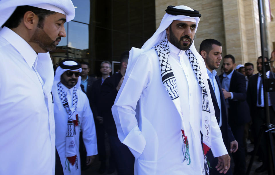 Khalifa al-Kuwari, center, director of the Qatar Fund for Development, walks out of the new Sheikh Hamad bin Khalifa Al Thani Hospital for Rehabilitation and Artificial Limbs in Gaza City, Monday, April 22, 2019. Qatar inaugurated the Gaza Strip's first prosthetic hospital and disability rehab center after many delays. Health officials say the 100-bed hospital is vital for Gaza, where more than 130 Palestinians have lost limbs over the past year during ongoing protests along Gaza-Israel perimeter fence. (AP Photo/Adel Hana)