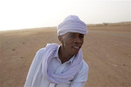 Toubou human smuggler Barka al Qatrun looks out for cars driven by his colleagues coming from Libya at a checkpoint outside Agadez, March 14, 2014. Picture taken March 14, 2014. REUTERS/Joe Penney