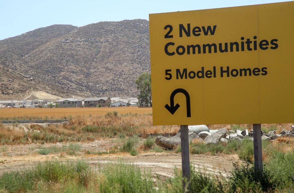 A sign advertises newly built homes on Domenigoni Parkway in Winchester, Calif., Aug. 14, 2023.