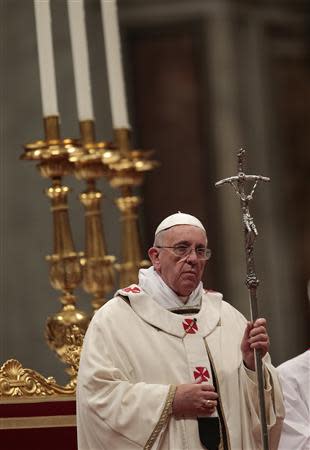 Pope Francis celebrates the Christmas night mass in the Saint Peter's Basilica at the Vatican December 24, 2013. REUTERS/Tony Gentile