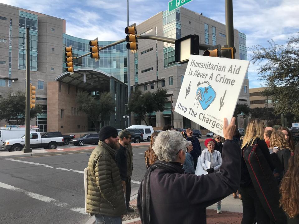 Dozens of No More Death volunteers and supporters rally in front of the Tucson federal courthouse on the first day of the trial against four volunteers charged for dropping off water for migrants at the Cabeza Prieta National Wildlife Refuge.