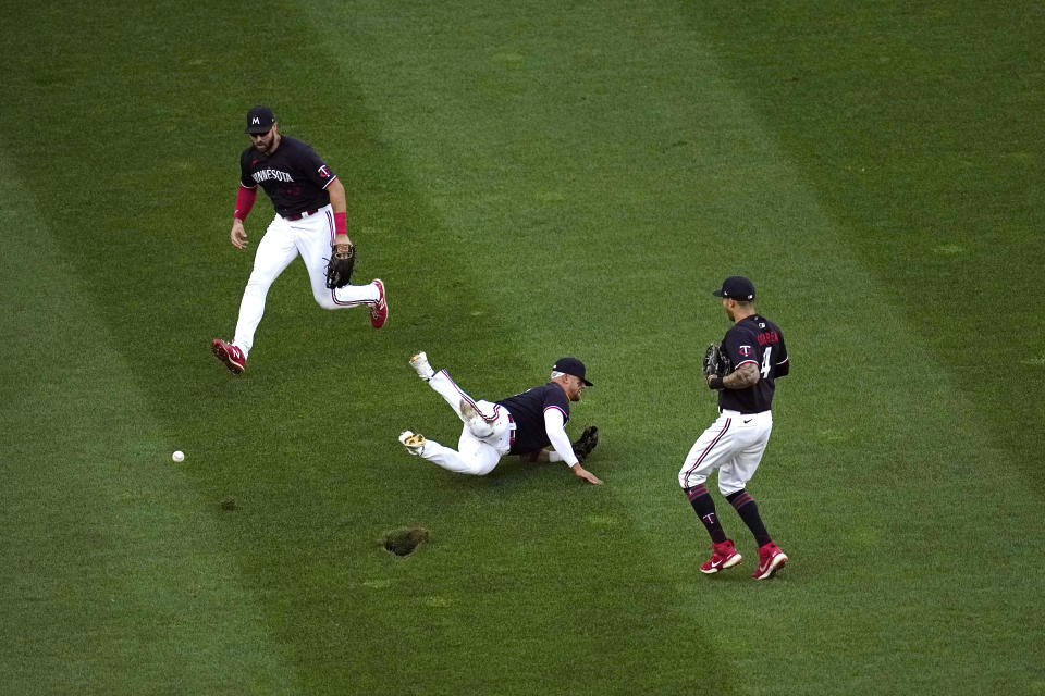 Minnesota Twins third baseman Royce Lewis, middle, cannot make the play on a popup by Cleveland Guardians' Andres Gimenez, who ended up with a double during the second inning of a baseball game Thursday, June 1, 2023, in Minneapolis. (AP Photo/Abbie Parr)