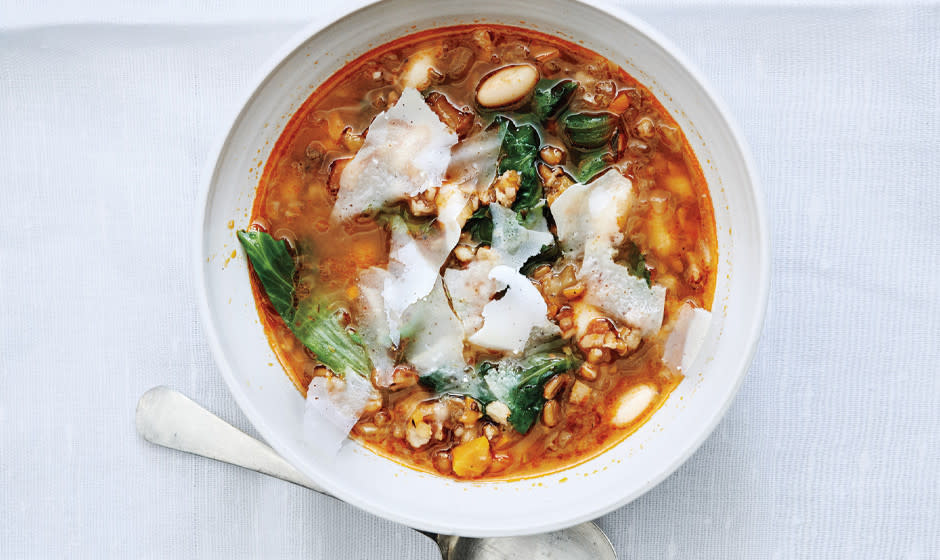 bowl of soup with a spoon on the side