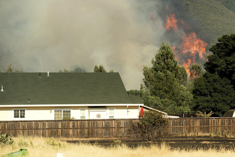 Wind-driven wildfires threatened homes in Northern California