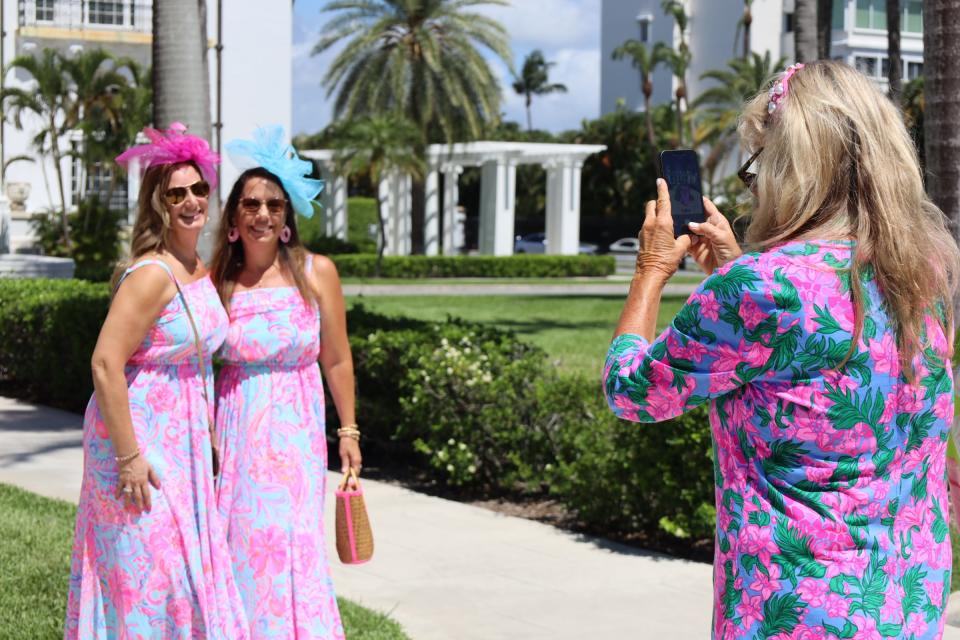 Women with The Pink Retreat pose for a photo in front of the Henry Morrison Flagler Museum. The museum hosted the retreat's afternoon tea, which has become one of the retreat's signature events.