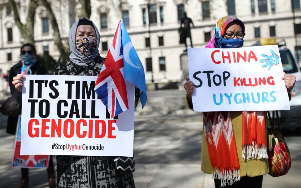 Uyghurs during a demonstration in Parliament Square, London, which is being held ahead of a House of Commons debate, bought by backbench MP Nus Ghani, on whether Uyghurs in China's Xinjiang province are suffering crimes against humanity and genocide - Yui Mok /PA