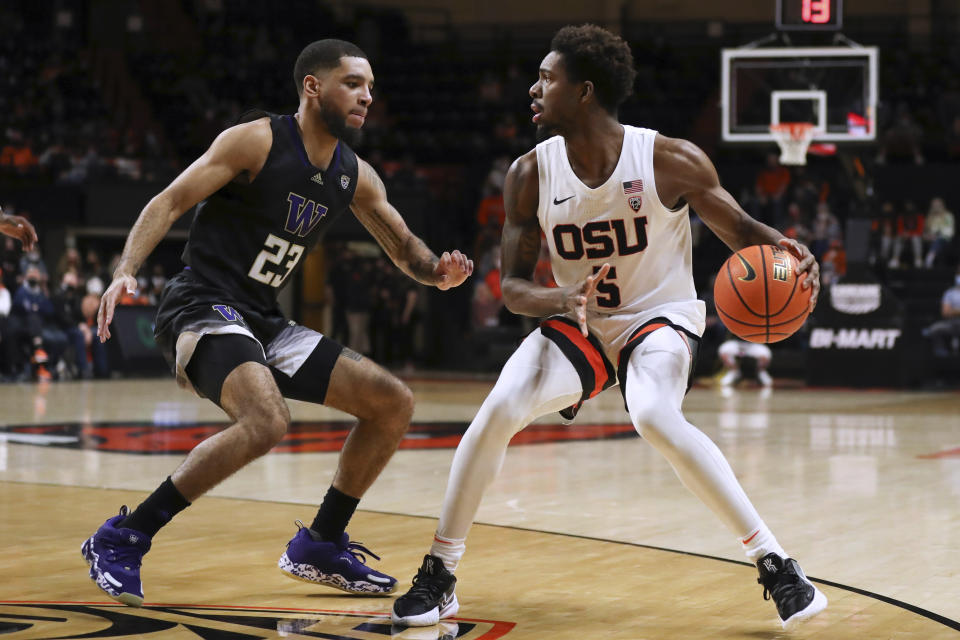 Washington's Terrell Brown Jr. (23) guards Oregon State's Xzavier Malone-Key (5) during the first half of an NCAA college basketball game Thursday, Jan. 20, 2022, in Corvallis, Ore. (AP Photo/Amanda Loman)