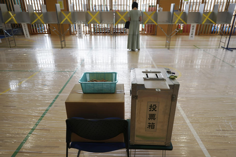 A voter prepares to cast a ballot in the Tokyo gubernatorial election at a polling station Sunday, July 5, 2020, in Tokyo. Gov. Yuriko Koike is poised to be reelected in Sunday’s polls, buoyed by public support for her coronavirus handling despite a recent rise in infections that has raised concerns of a resurgence of the disease. (AP Photo/Eugene Hoshiko)