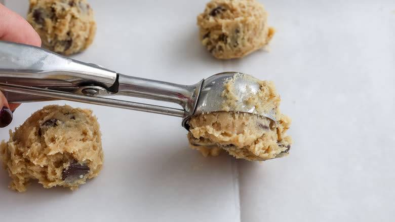cookie dough being scooped onto a pan
