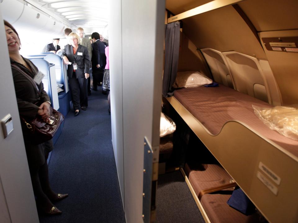 Visitors tour a crew rest area off of the new business elite class interior of a Delta Air Lines 747-400 airplane, Monday, Oct. 8, 2012, at Seattle-Tacoma International Airport in Seattle.