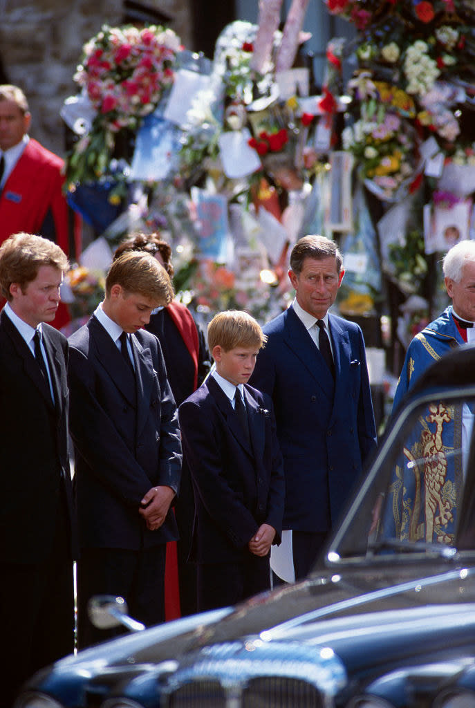 The boys, their father, and their Uncle Charles Spencer watch as Princess Diana's hearse goes by