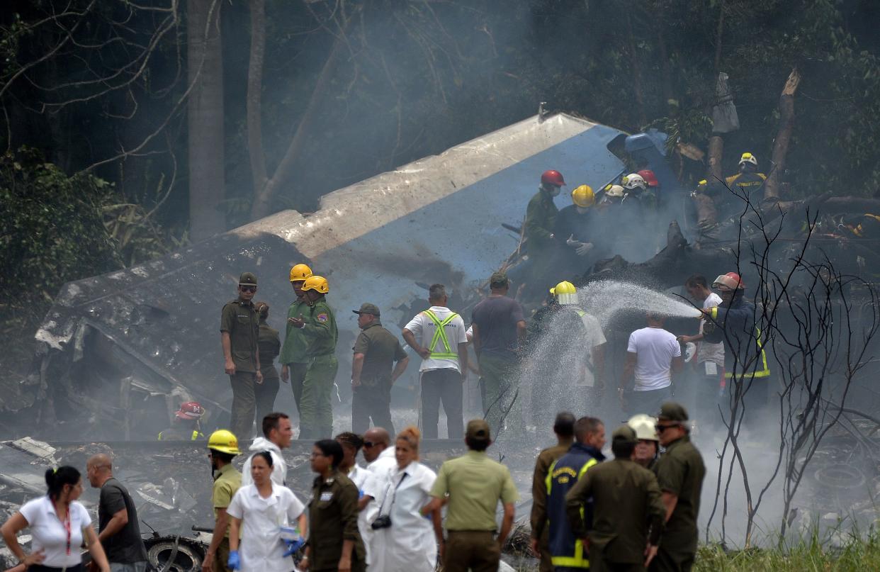 Emergency personnel work at the site of a plane&nbsp;crash outside Havana&rsquo;s Jose Marti International Airport on&nbsp;Friday.&nbsp; (Photo: YAMIL LAGE via Getty Images)