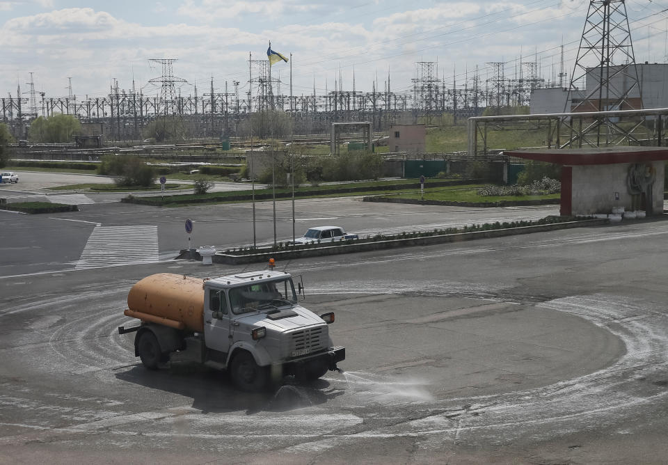 <p>A water tanker sprays water on a road to prevent radioactive dust from being blown away in front of the Chernobyl nuclear power plant in Chernobyl, Ukraine, April 20, 2018. (Photo: Gleb Garanich/Reuters) </p>