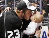 Los Angeles Kings' Dustin Brown kisses his daughter Mackenzie after the Kings defeated the New York Rangers in Game 5 of their NHL Stanley Cup Finals hockey series in Los Angeles, California, June 13, 2014. REUTERS/Lucy Nicholson