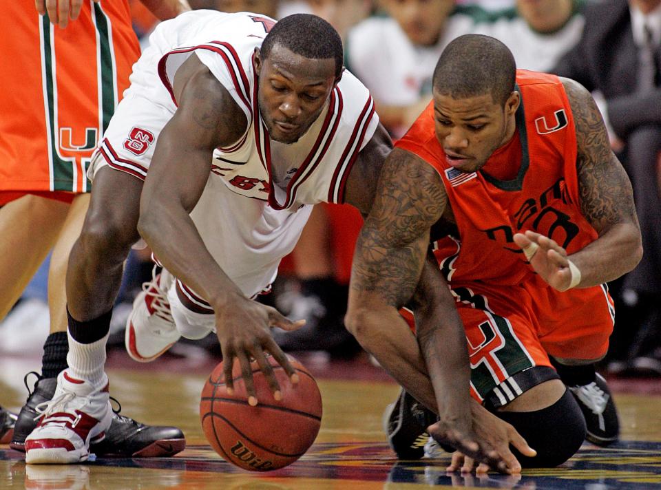 North Carolina State's Courtney Fells, left, battles for the loose ball with Miami's Jack McClinton during the second half of a college basketball game in Raleigh, N.C., Saturday, Jan. 19, 2008. Fells had 14 points for State and McClinton had 26 points in the 79-77 North Carolina State win in overtime.