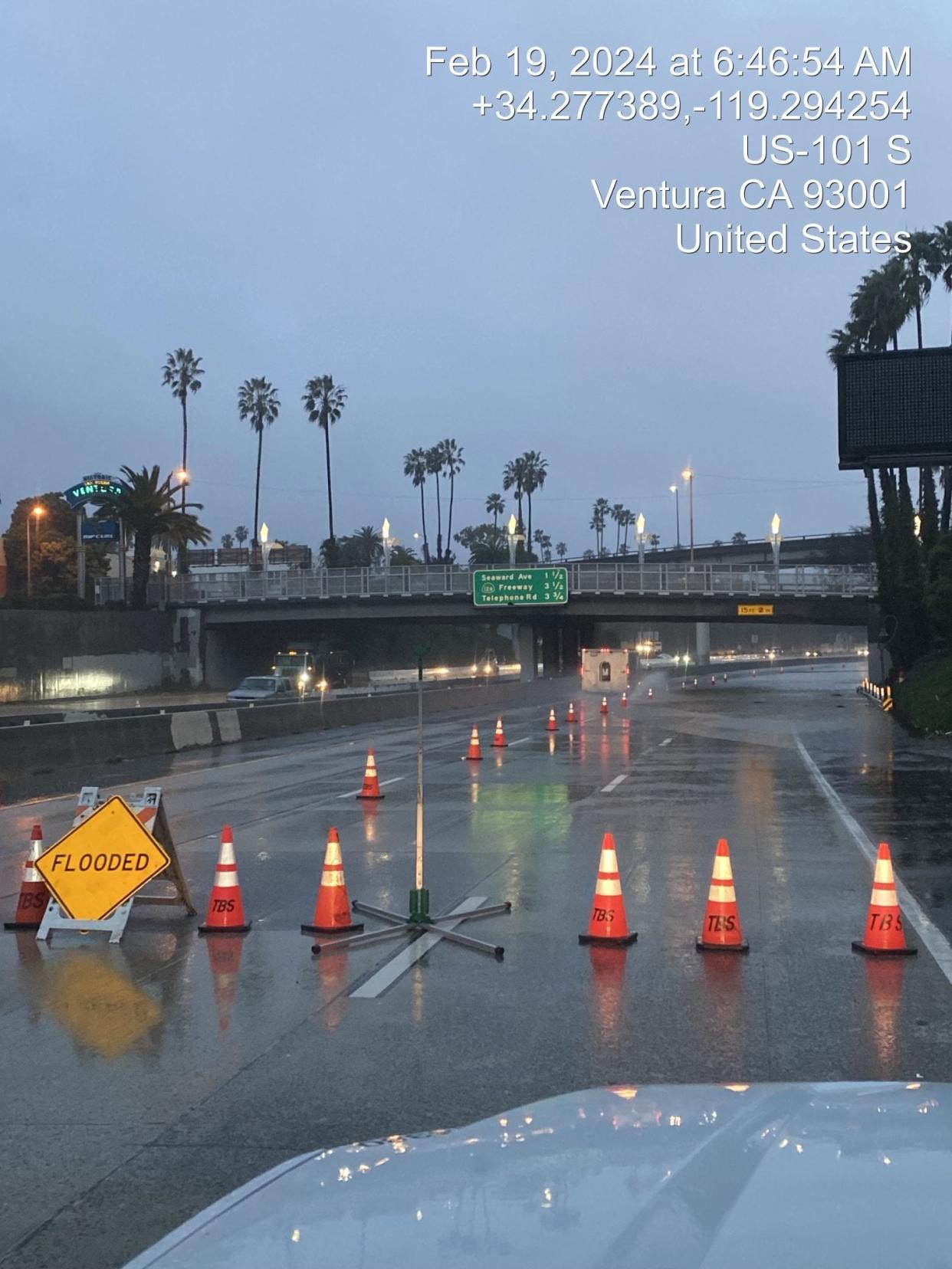 Cones and signs block off a portion os US-101 in Ventura, California as heavy rain pours down (California Department of Transportation)