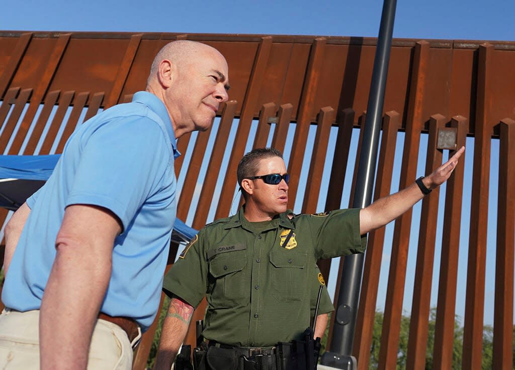 Homeland Security Secretary Alejandro Mayorkas, left, listens to Deputy patrol agent in charge of the US Border Patrol Anthony Crane as he tours the section of the border wall Tuesday, May 17, 2022, in Hidalgo, Texas. (Joel Martinez/The Monitor via AP, Pool)