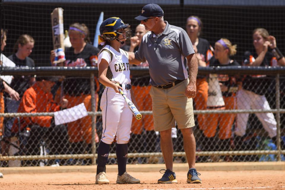 Cape Fear lead-off batter Haley Cashwell talks to coach Jeff McPhail during the 2017 state 4-A championship game in Greensboro.