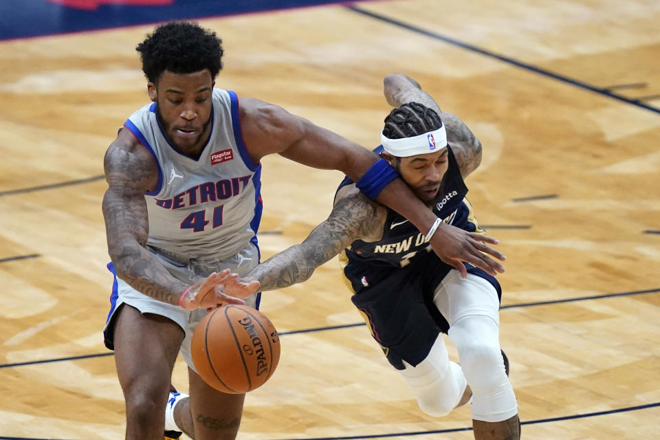 Detroit Pistons forward Saddiq Bey (41) and New Orleans Pelicans forward Brandon Ingram reach for the ball during the first half of an NBA basketball game in New Orleans, Wednesday, Feb. 24, 2021. (AP Photo/Gerald Herbert)