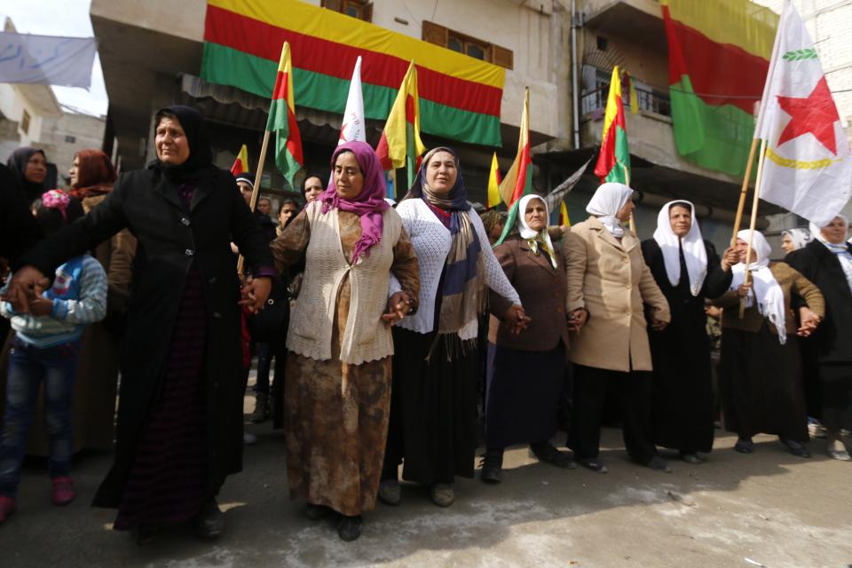 Kurdish women perform traditional dance as they celebrate, after reports of Kurdish forces taking control of Syrian town of Kobani, in Aleppo