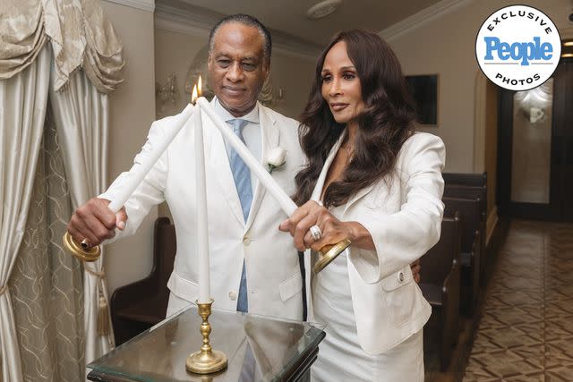 <p>Courtesy Beverly Johnson & Brian Maillian</p> Beverly Johnson and Brian Maillian light candles at their wedding