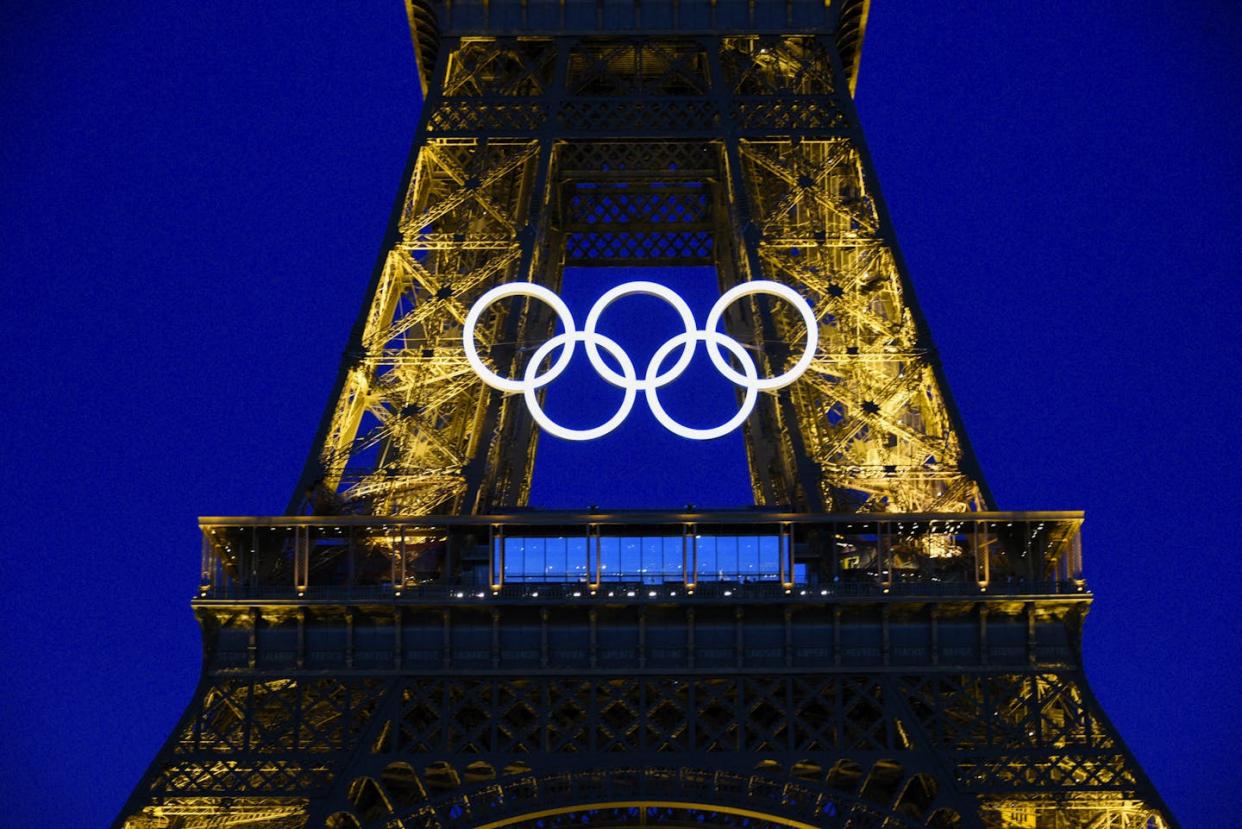 The Olympic rings on the Eiffel Tower in Paris, ahead of the upcoming 2024 Paris Olympics. <a href="https://www.gettyimages.com/detail/news-photo/the-olympic-rings-on-the-eiffel-tower-in-paris-at-night-news-photo/2156345081?searchscope=image%2Cfilm&adppopup=true" rel="nofollow noopener" target="_blank" data-ylk="slk:Magali Cohen / Hans Lucas / Hans Lucas via AFP;elm:context_link;itc:0;sec:content-canvas" class="link ">Magali Cohen / Hans Lucas / Hans Lucas via AFP</a>
