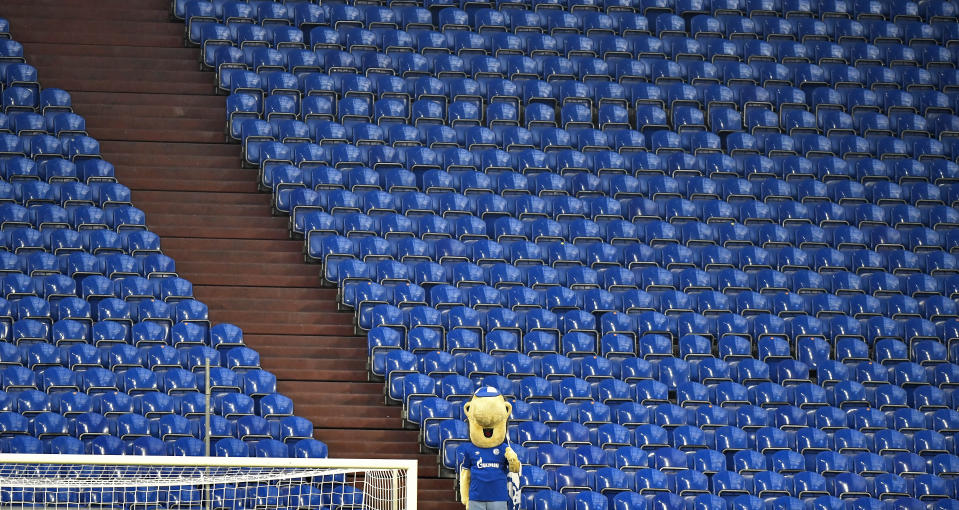 Schalke's mascot watches from the empty tribune during the German Bundesliga soccer match between FC Schalke 04 and Bayern Munich in Gelsenkirchen, Germany, Sunday, Jan. 24, 2021. (AP Photo/Martin Meissner, Pool)