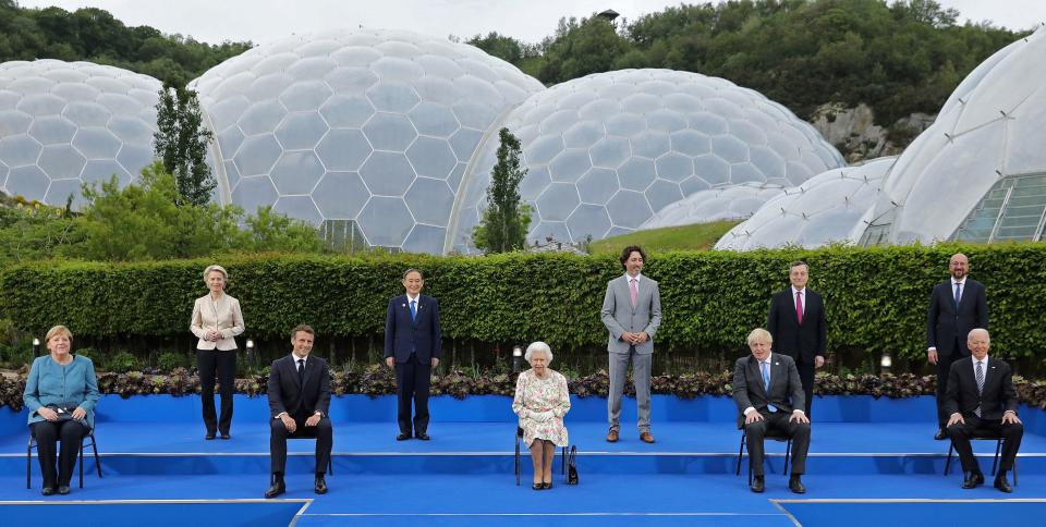 Britain's Queen Elizabeth II (C), poses for a family photograph with, from left, Germany's Chancellor Angela Merkel, President of the European Commission Ursula von der Leyen, France's President Emmanuel Macron, Japan's Prime Minister Yoshihide Suga, Canada's Prime Minister Justin Trudeau, Britain's Prime Minister Boris Johnson , Italy's Prime minister Mario Draghi, President of the European Council Charles Michel and US President Joe Biden, during an evening reception at The Eden Project in south west England on June 11, 2021. - G7 leaders from Canada, France, Germany, Italy, Japan, the UK and the United States meet this weekend for the first time in nearly two years, for three-day talks in Carbis Bay, Cornwall. (Photo by JACK HILL / POOL / AFP) (Photo by JACK HILL/POOL/AFP via Getty Images)