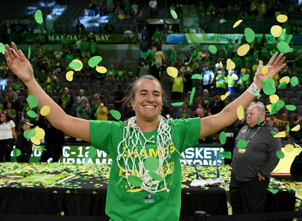  Sabrina Ionescu #20 of the Oregon Ducks wears a basketball net around her neck and throws confetti in the air as she celebrates her team's 89-56 win over the Stanford Cardinal to win the championship game of the Pac-12 Conference women's basketball tournament at the Mandalay Bay Events Center on March 8, 2020 in Las Vegas, Nevada.  (Photo by Ethan Miller/Getty Images)