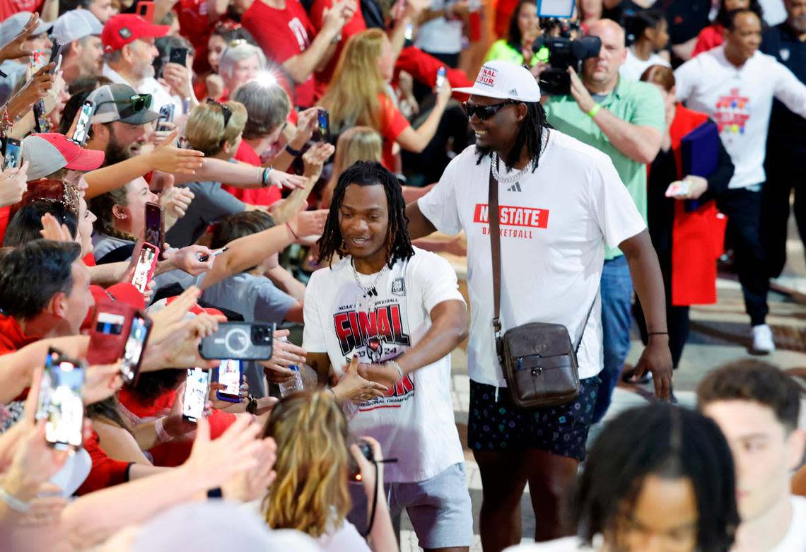 N.C. State’s DJ Horne and DJ Burns Jr. greet fans as they walk towards the belltower during a celebration for the N.C. State men’s and women’s basketball team at the Memorial Belltower in Raleigh, N.C., Monday, April 15, 2024. Both teams made it to the NCAA Tournament Final Four and the men’s team won the ACC Championship by winning five games in five days.