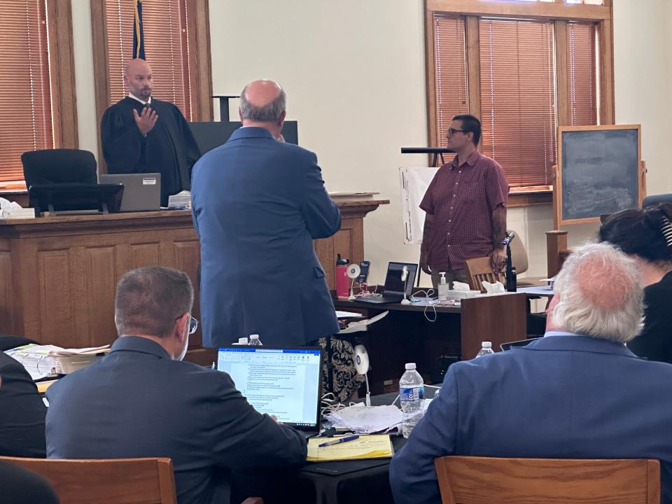 13th Circuit Court Judge Charles Hamlyn speaks to the courtroom before adjourning court for the day on Sept. 7, 2023. Eric Molitor (right back) listens along with his attorney William Barnett (standing center).