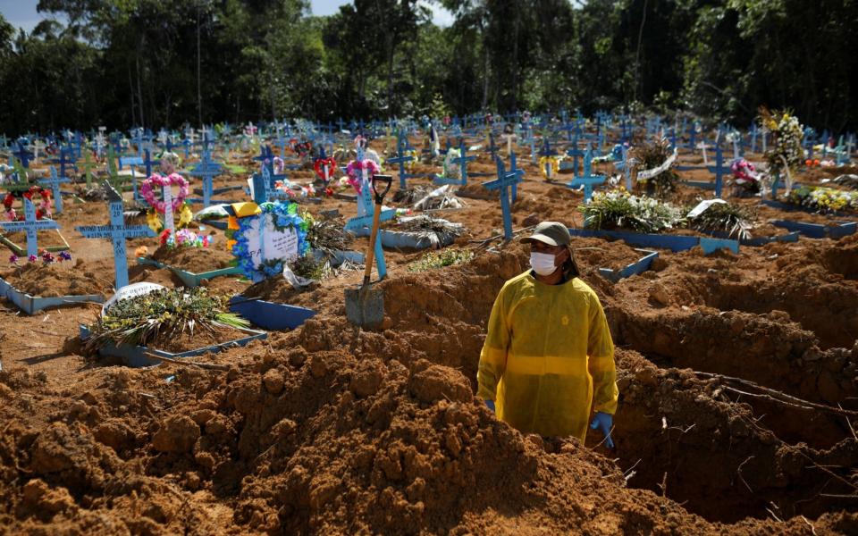 A gravedigger works at the Parque Taruma cemetery amid the coronavirus outbreak in Manaus, Brazil, - Reuters