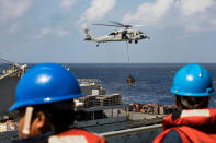 <p>Sailors aboard the amphibious assault ship USS Kearsarge (LHD 3) observe as an MH-60 Sea Hawk helicopter transfers pallets of supplies from the fast combat support ship USNS Supply (T-AOE 6) during replenishment-at-sea for continuing operations as part of Hurricane Maria relief efforts in Puerto Rico on Sept. 28, 2017. (Photo: Jacob A. Goff/U.S. Navy/Handout via Reuters) </p>