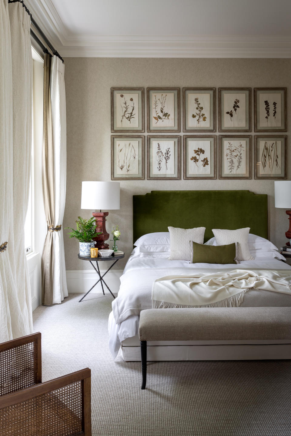 Neutral bedroom with green headboard and gallery wall