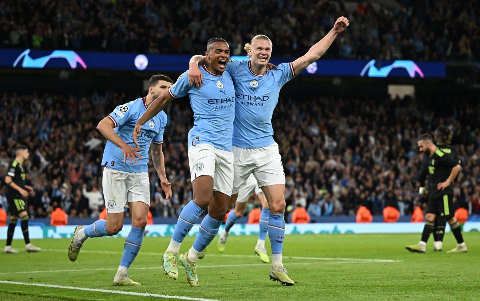 Manchester City's Swiss defender Manuel Akanji (L) celebrates scoring the team's third goal with Manchester City's Norwegian striker Erling Haaland during the UEFA Champions League second leg semi-final football match between Manchester City and Real Madrid at the Etihad Stadium in Manchester, north west England, on May 17, 2023. (Photo by Oli SCARFF / AFP) (Photo by OLI SCARFF/AFP via Getty Images)