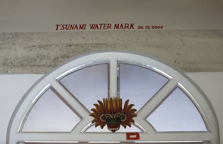 The water level of the 2004 Tsunami is seen marked above a main door at The Foundation of Goodness village project in Seenigama December 20, 2014. REUTERS/Dinuka Liyanawatte