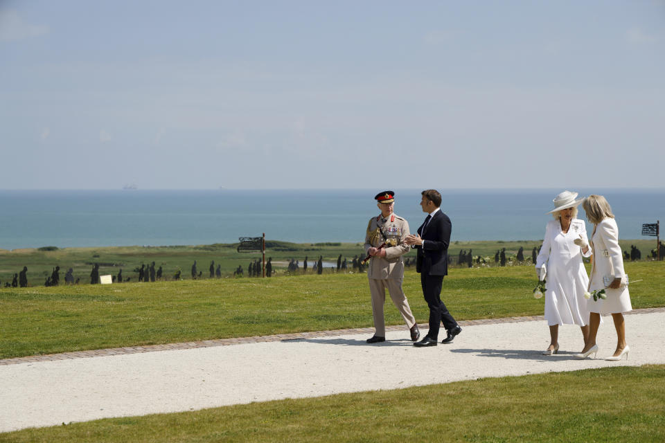 French President Emmanuel Macron, second left, Britain's King Charles III, Britain's Queen Camilla with Brigitte Macron, right, discuss during a commemorative ceremony marking the 80th anniversary of the World War II D-Day" Allied landings in Normandy, at the World War II British Normandy Memorial of Ver-sur-Mer, Thursday, June 6, 2024. Normandy is hosting various events to officially commemorate the 80th anniversary of the D-Day landings that took place on June 6, 1944. (Ludovic Marin/Pool via AP)