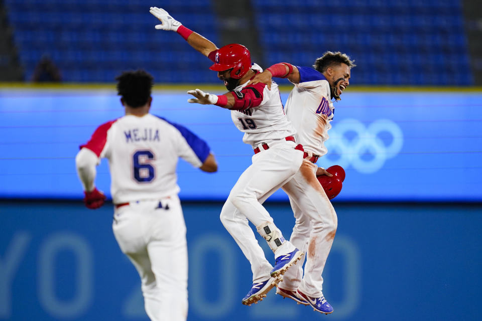 Dominican Republic's Jose Bautista (19) celebrate with Gustavo Nunez after hitting the game winning RBI single during the ninth inning of a baseball game against Israel at the 2020 Summer Olympics, Tuesday, Aug. 3, 2021, in Yokohama, Japan. The Dominican Republic won 7-6. (AP Photo/Matt Slocum)