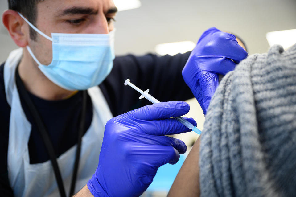 LONDON, ENGLAND - NOVEMBER 10: A woman receives her Covid-19 vaccination booster jab at the Sir Ludwig Guttmann Health & Wellbeing Centre on November 10, 2021 in the Stratford area of London, England. Over 10 million people have now received their Covid-19 vaccine boosters in the UK, as the government has allowed people over 50 and the clinically vulnerable to receive third jabs. (Photo by Leon Neal/Getty Images)