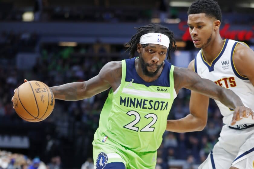 Minnesota Timberwolves guard Patrick Beverly (22) works around Denver Nuggets guard PJ Dozier (35) in the first quarter of a NBA basketball game Saturday, Oct. 30, 2021, in Minneapolis. (AP Photo/Bruce Kluckhohn)