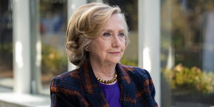 Hillary Clinton sits at a table.